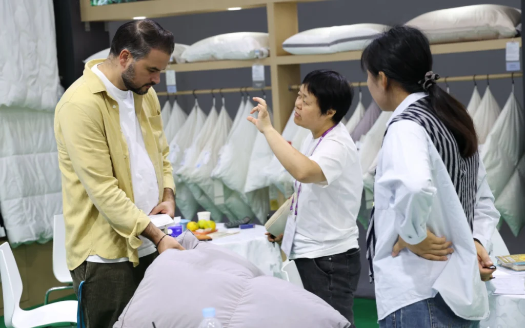 The exhibitor is introducing the product to the buyer