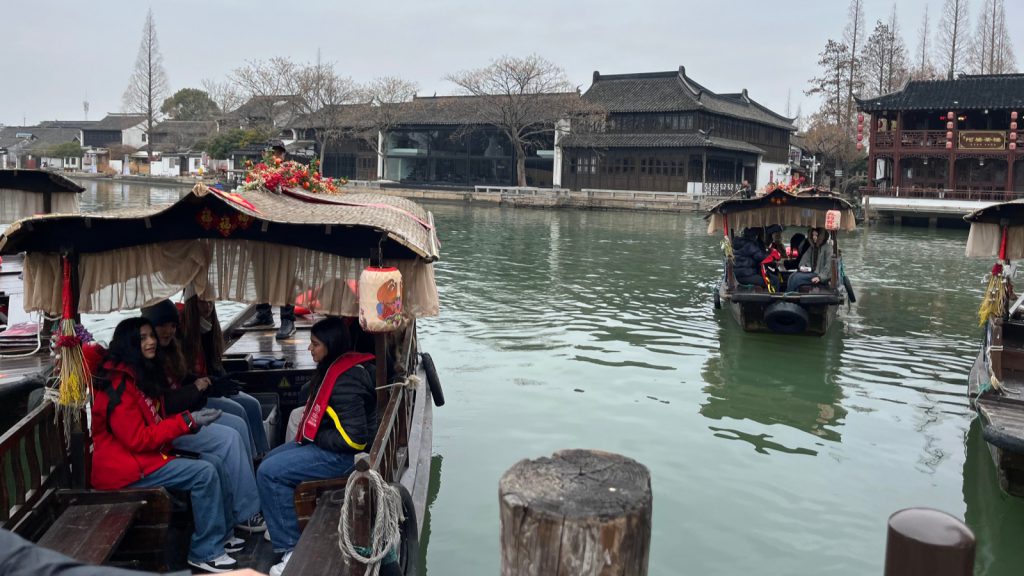 The student group exploring Zhujiajiao Water Town by traditional boat.