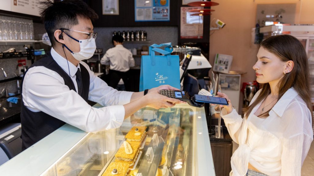 A tourist paying with Alipay at a bakery in China.
