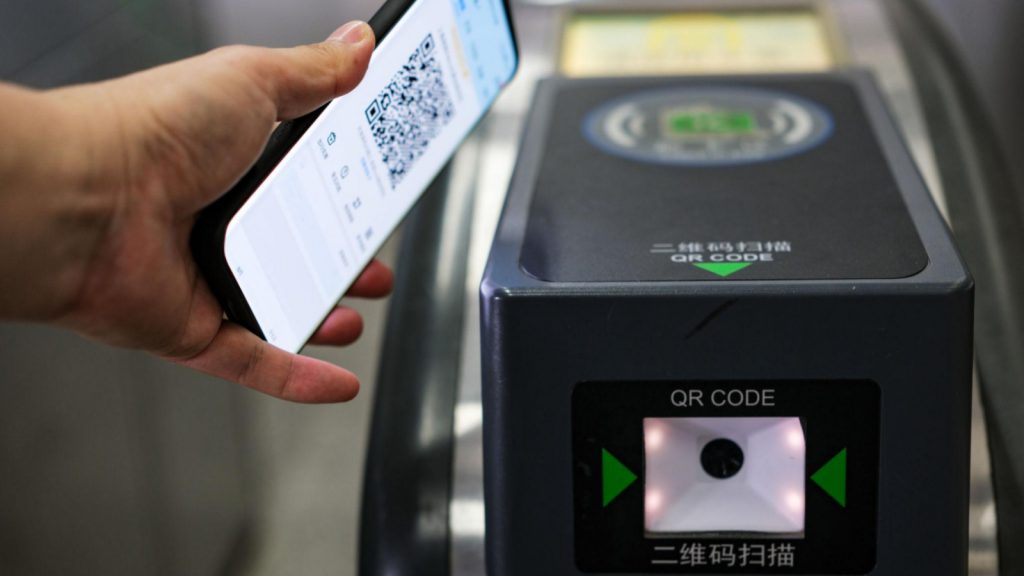 Scanning a QR code to pay for public transport in China.