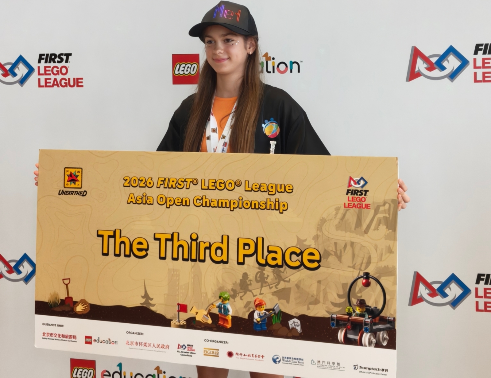 Student holds a third-place board at the 2026 FLL Asia Open Championship in Beijing