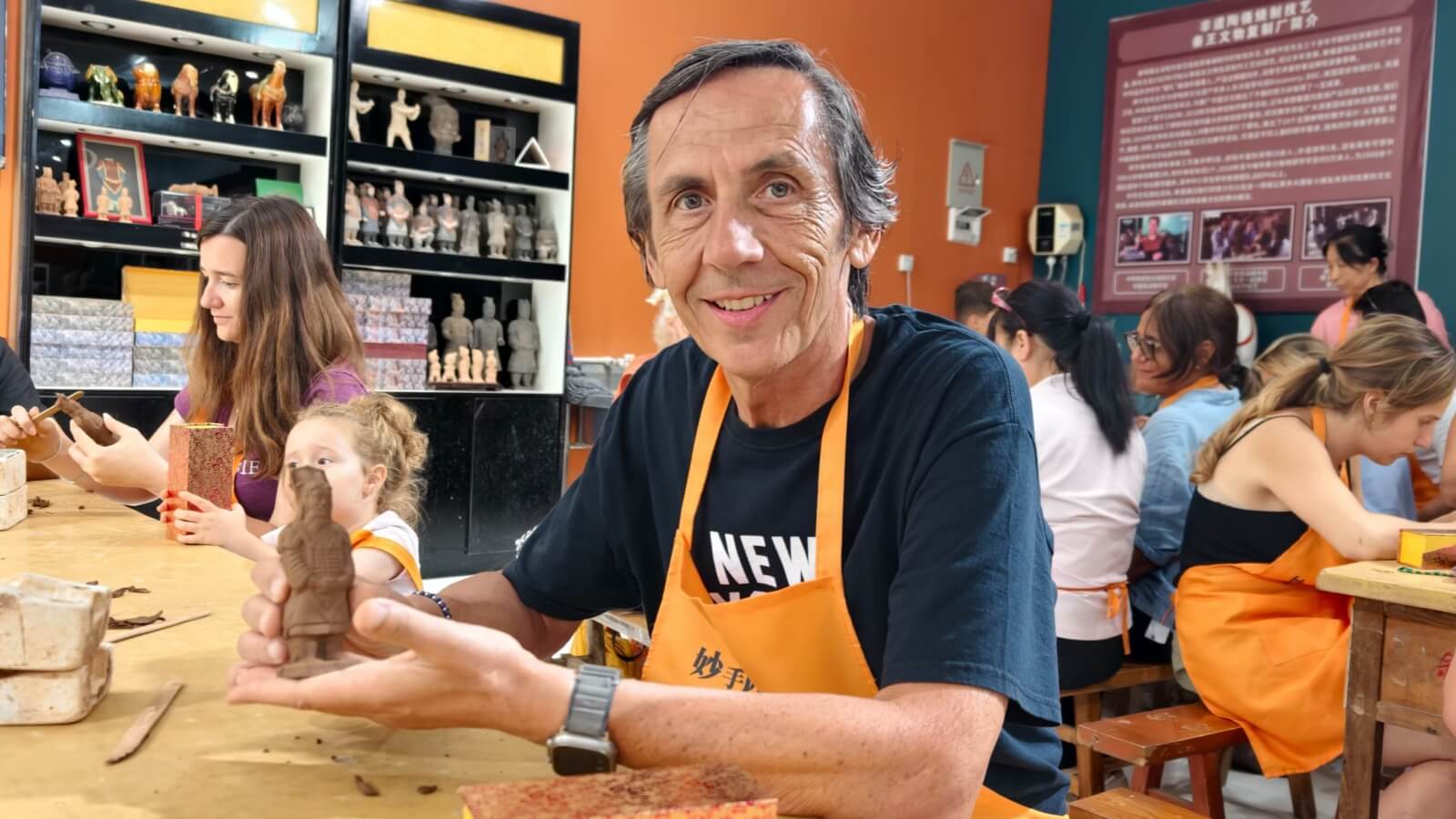 The teacher showing his clay warrior