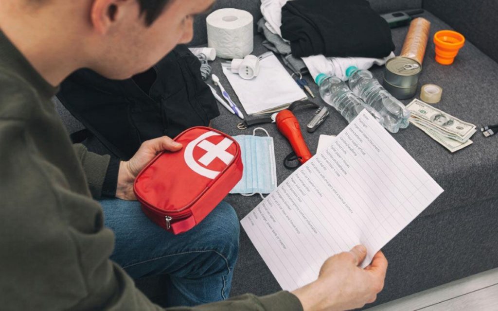 Teacher checking a first aid kit and travel documents before a school trip to China